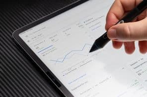 Browsing Google ads chart report on tablet screen macro close up view.