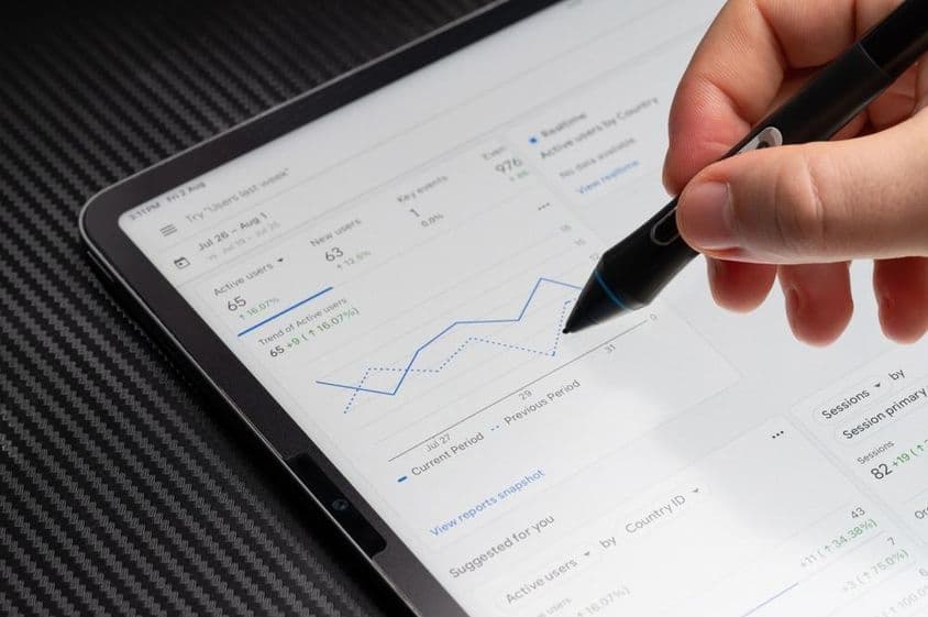 Browsing Google ads chart report on tablet screen macro close up view.