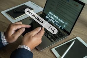 Businessman search website for content keywords on laptop.