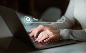 Focused worker researching SEO information or tech data analytics.