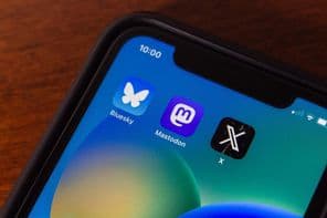 Bluesky and X app icons on an iPhone screen.
